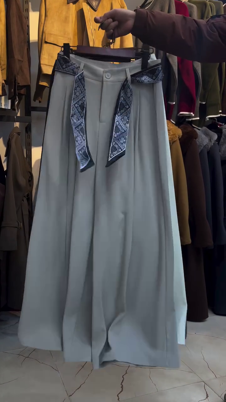 “Effortless Elegance: High-Waisted Grey Pleated Wide-Leg Trousers”