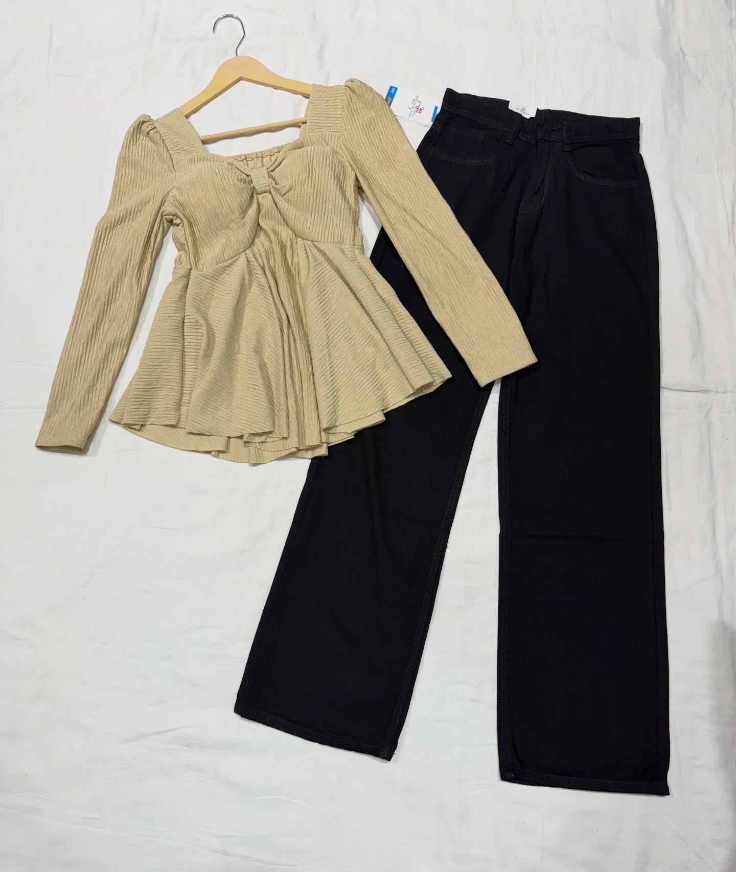 “Effortless Chic: Black Peplum Top with Wide-Leg Denim Jeans”