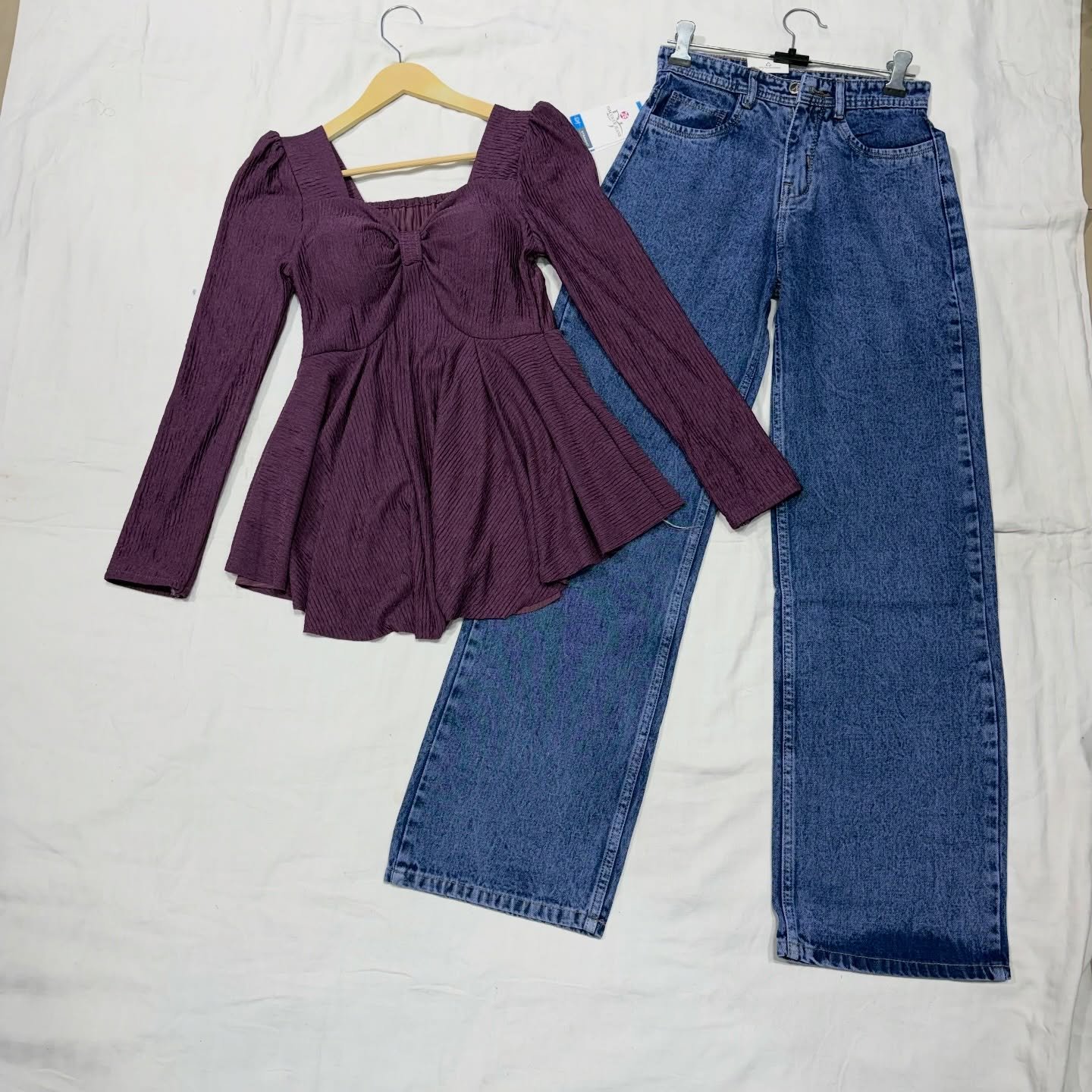 “Effortless Chic: Black Peplum Top with Wide-Leg Denim Jeans”