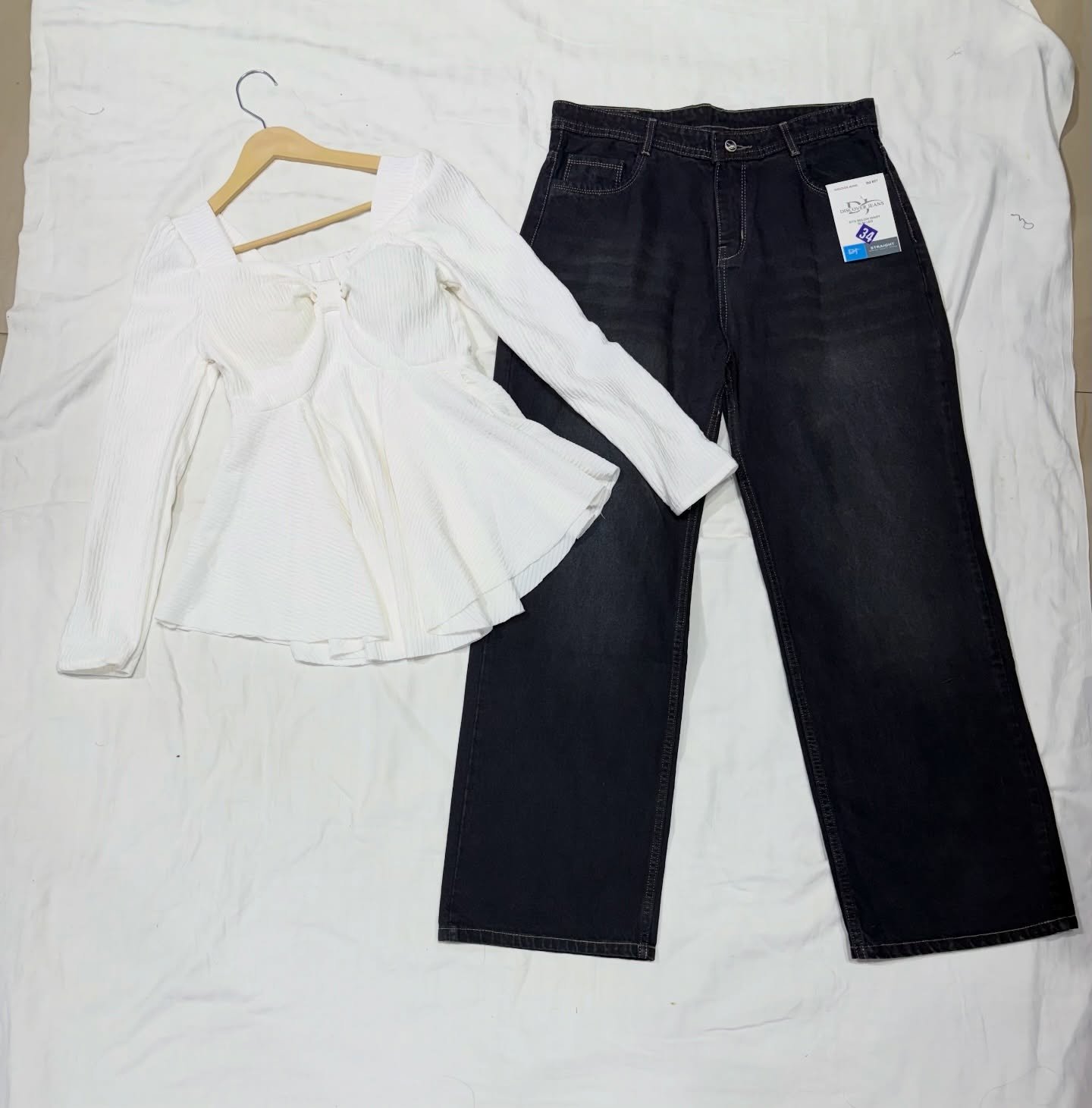 “Effortless Chic: Black Peplum Top with Wide-Leg Denim Jeans”