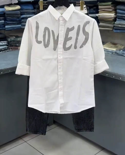 White “LOVEIS.” Graphic Shirt with Dark Jeans – Minimal Style, Maximum Impact