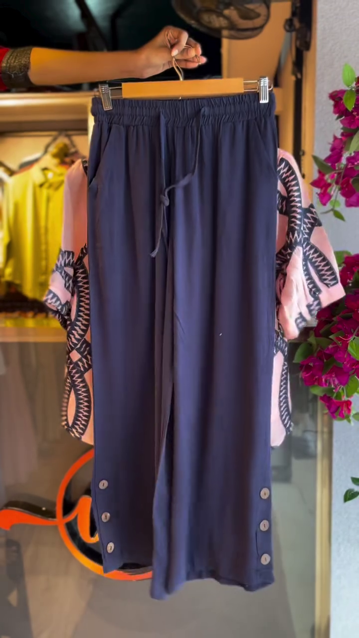 “Chic & Coordinated: Styling a Pink Patterned Top with Dark Trousers”