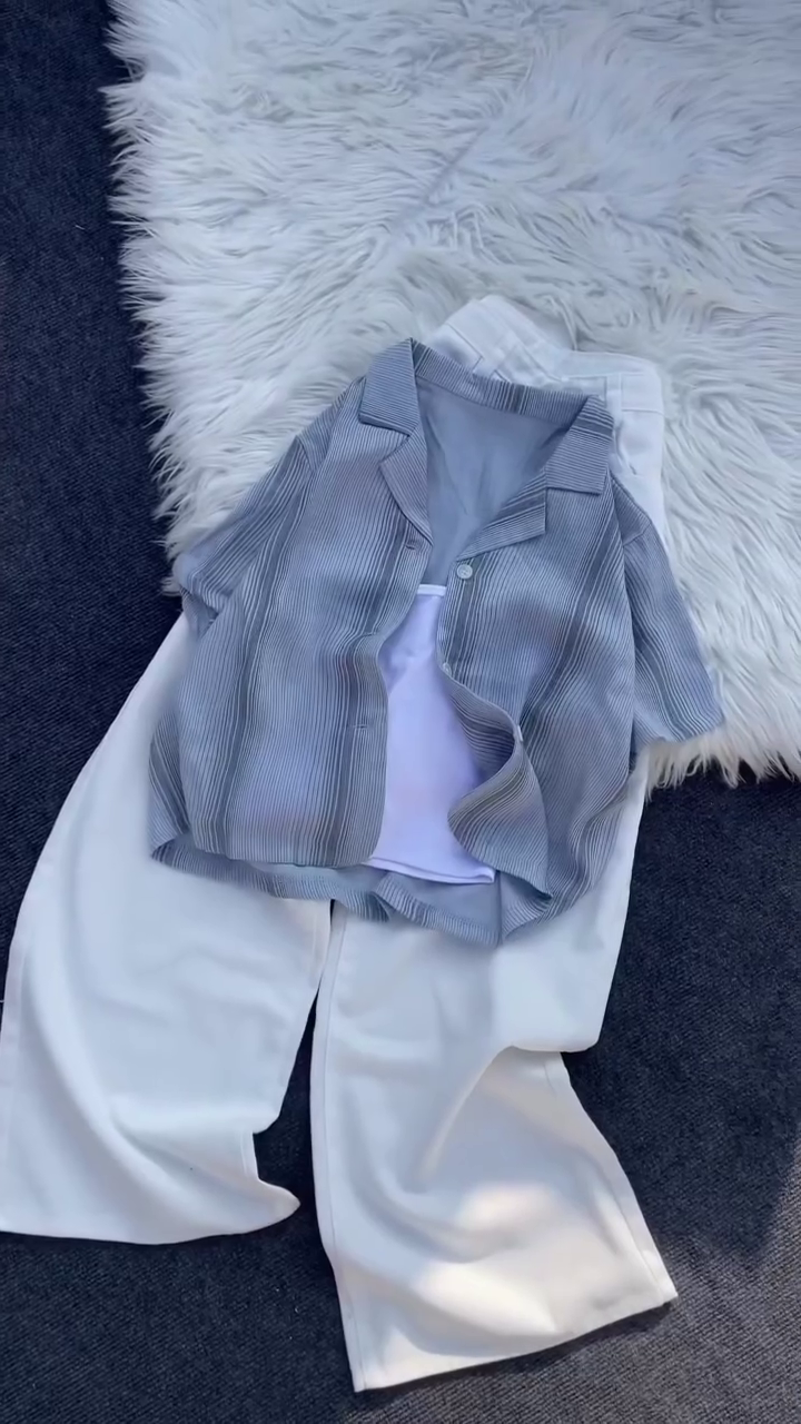 “Monochrome Chic: Layered Pleated Shirt with White Wide-Leg Trousers”