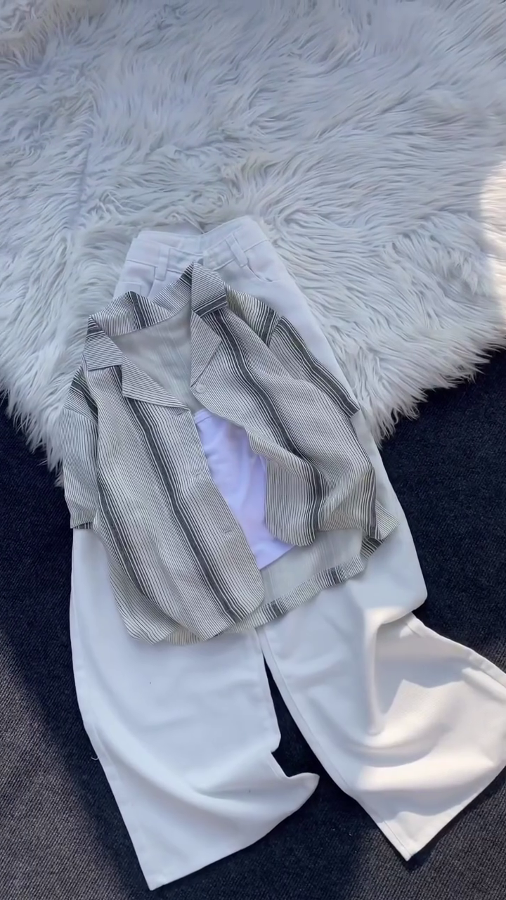“Monochrome Chic: Layered Pleated Shirt with White Wide-Leg Trousers”