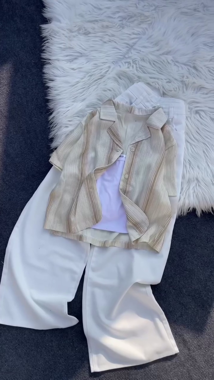 “Monochrome Chic: Layered Pleated Shirt with White Wide-Leg Trousers”
