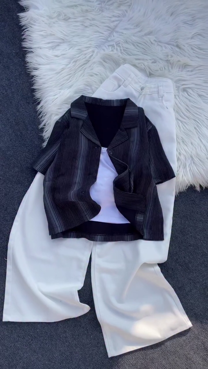 “Monochrome Chic: Layered Pleated Shirt with White Wide-Leg Trousers”