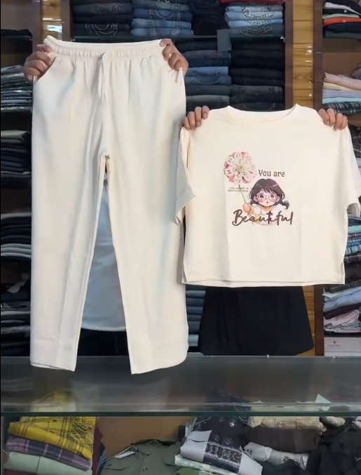 Soft & Stylish Comfort: Pastel Pink Cotton Co-Ord Set for Girls with Graphic T-Shirt & Wide-Leg Trousers